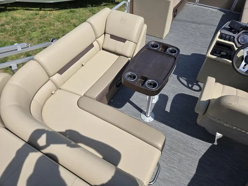 Slide: The Image of 2025 Godfrey Sweetwater 2186 C Sport Tube interior with beige seating and table. - 11