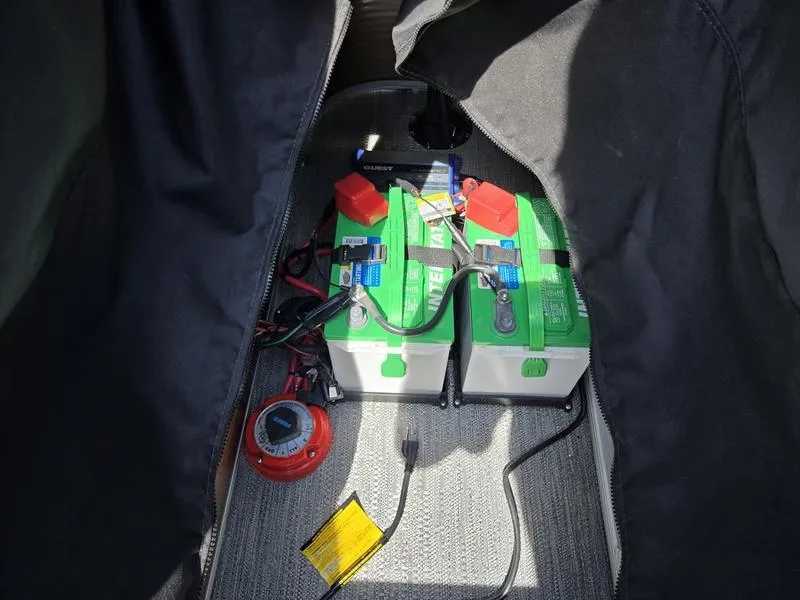 Slide: The Image of Batteries and wiring inside a 2025 Godfrey Sweetwater 2186 C Sport Tube boat. - 13