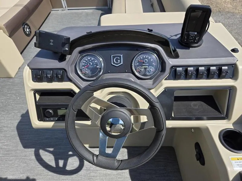 Slide: The Image of 2025 Godfrey Sweetwater 2186 C Sport Tube dashboard with steering wheel and controls. - 14