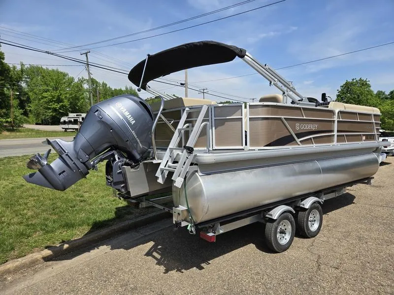 Slide: The Image of 2025 Godfrey Sweetwater 2186 C Sport Tube pontoon boat on trailer with Yamaha outboard motor. - 3