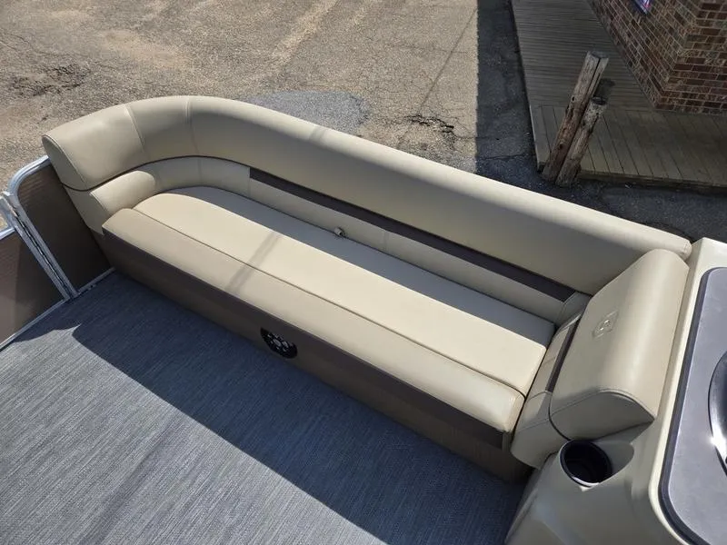 Slide: The Image of 2025 Godfrey Sweetwater 2186 C Sport Tube boat interior with beige seating and cup holder. - 5