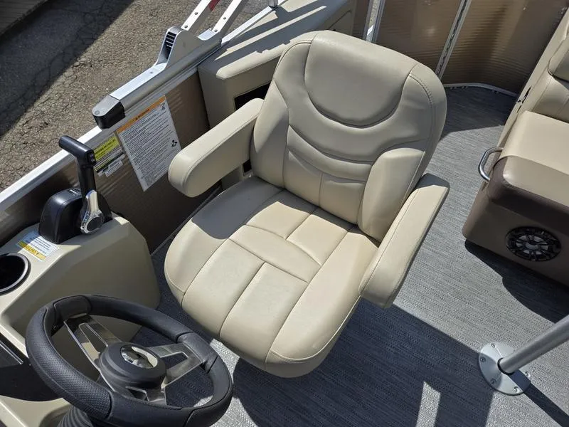 Slide: The Image of Captain's chair on 2025 Godfrey Sweetwater 2186 C Sport Tube boat, featuring plush seating and steering wheel. - 8