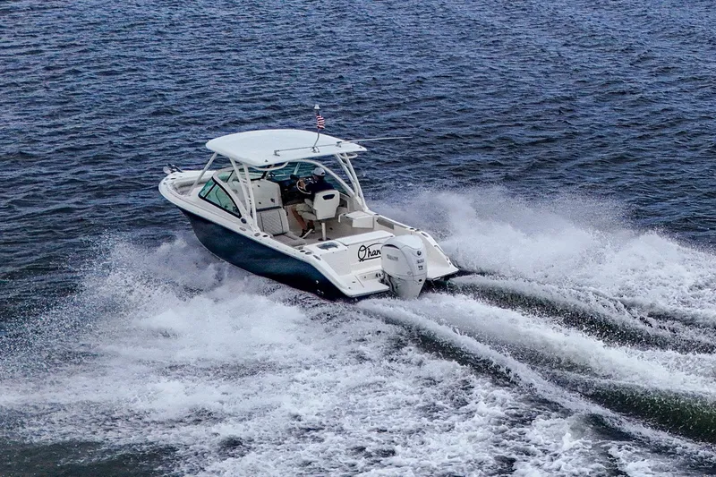 Slide: The Image of 2021 Pursuit DC 246 Dual Console boat cruising on open water. - 17