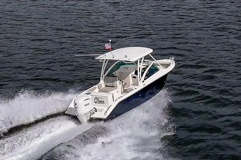 Slide: The Image of 2021 Pursuit DC 246 Dual Console boat cruising on open water. - 20