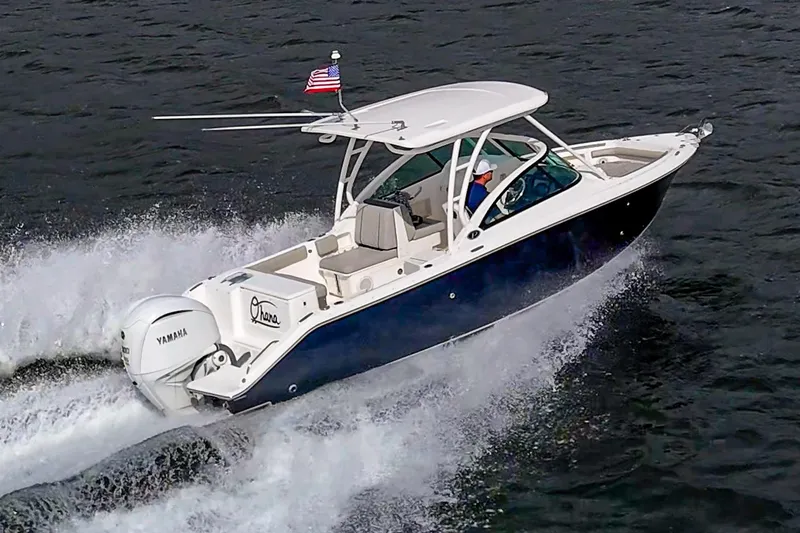 Slide: The Image of 2021 Pursuit DC 246 Dual Console boat cruising on water with Yamaha engine. - 21