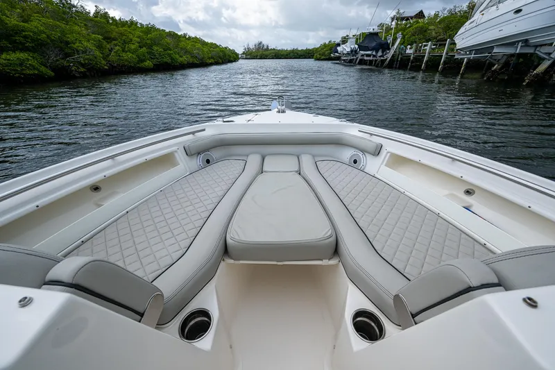 Slide: The Image of 2021 Pursuit DC 246 Dual Console boat with spacious seating on a calm waterway. - 22