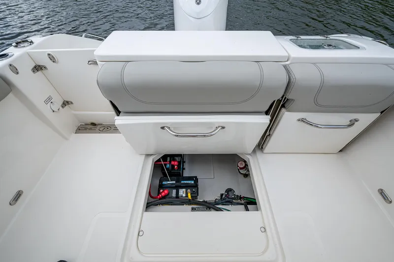 Slide: The Image of 2021 Pursuit DC 246 Dual Console boat interior with open storage compartment. - 33