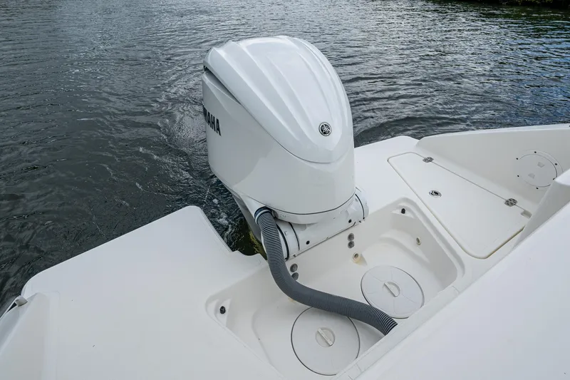 Slide: The Image of 2021 Pursuit DC 246 Dual Console boat with Yamaha outboard motor on water. - 34