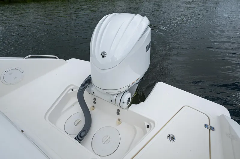Slide: The Image of 2021 Pursuit DC 246 Dual Console boat with outboard motor on water. - 35