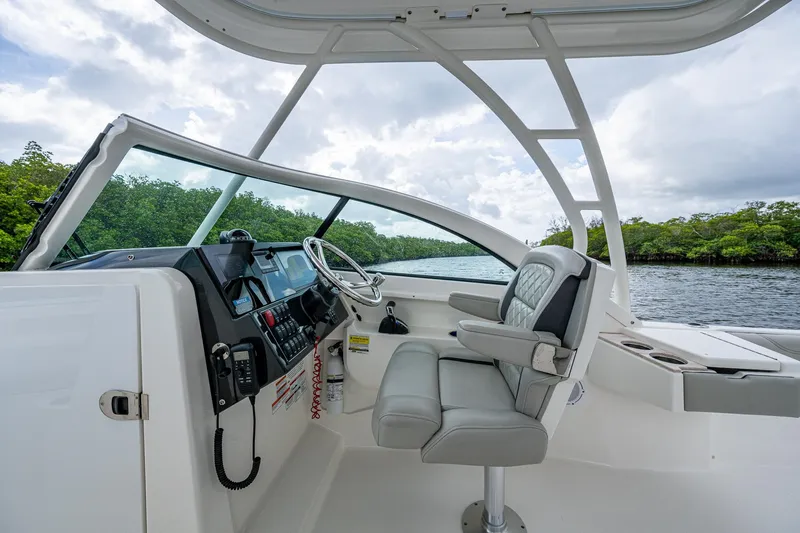 Slide: The Image of 2021 Pursuit DC 246 Dual Console boat interior with helm and seating. - 38