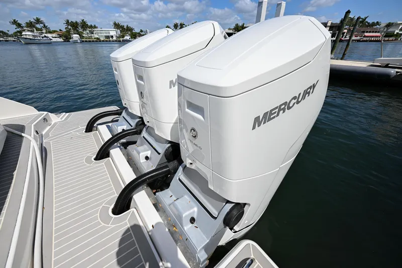 Slide: The Image of 2023 Tiara Yachts 48 LS with dual Mercury outboard engines on a sunny day. - 12