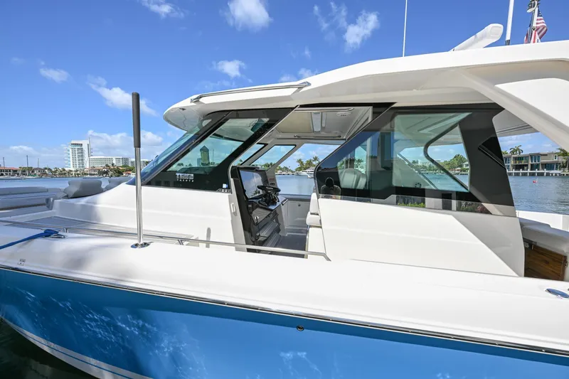 Slide: The Image of 2023 Tiara Yachts 48 LS, sleek design, docked under clear blue sky. - 15