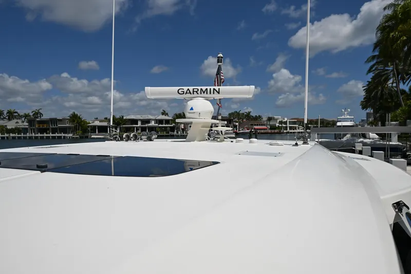 Slide: The Image of 2023 Tiara Yachts 48 LS with Garmin radar, docked under a clear blue sky. - 17