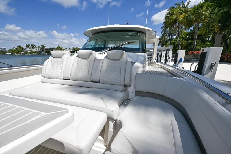 Slide: The Image of 2023 Tiara Yachts 48 LS luxury yacht with plush seating and scenic waterfront view. - 21