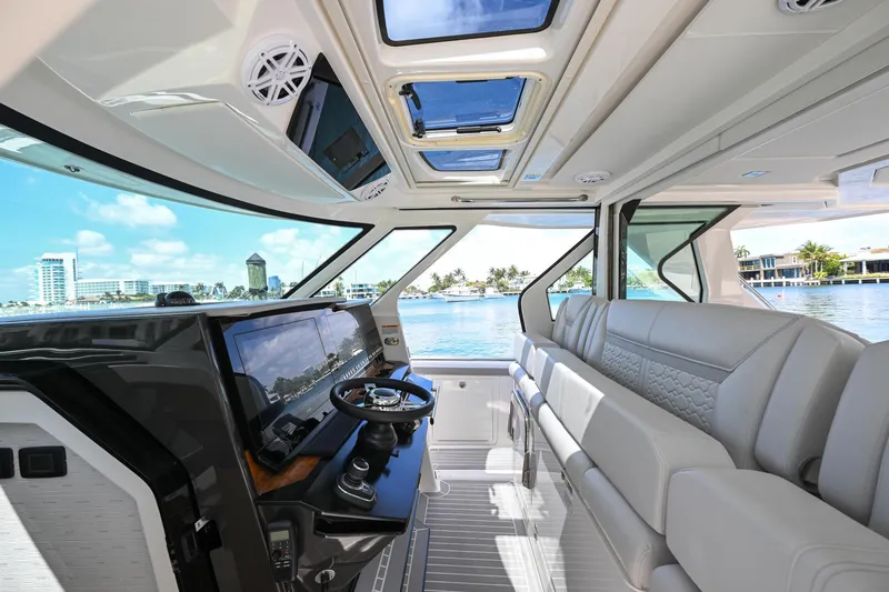Slide: The Image of 2023 Tiara Yachts 48 LS interior with luxurious seating and panoramic windows. - 28