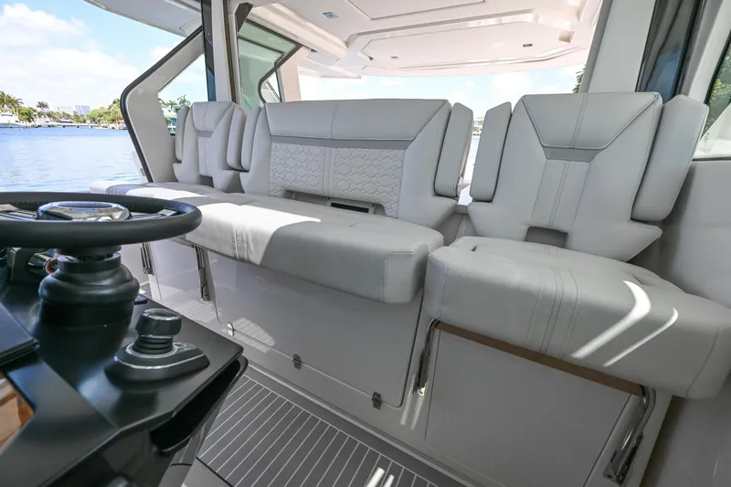 Slide: The Image of 2023 Tiara Yachts 48 LS interior with luxurious seating and modern helm controls. - 30