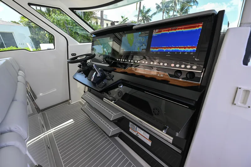 Slide: The Image of Helm of 2023 Tiara Yachts 48 LS with advanced navigation displays and controls. - 34