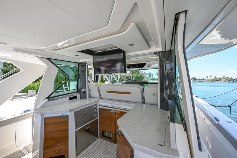 Slide: The Image of 2023 Tiara Yachts 48 LS interior with modern kitchen and waterfront view. - 40