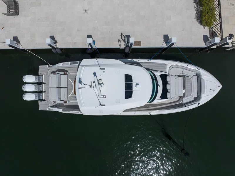 Slide: The Image of Aerial view of 2023 Tiara Yachts 48 LS docked, showcasing sleek design and triple engines. - 6