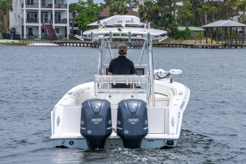 Slide: The Image of 2014 Contender 30st boat with dual 300 horsepower engines on a calm waterway. - 10