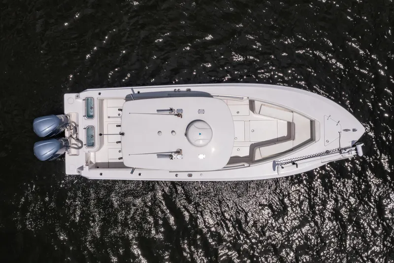 Slide: The Image of Aerial view of 2014 Contender 30st boat on water, featuring dual engines. - 12