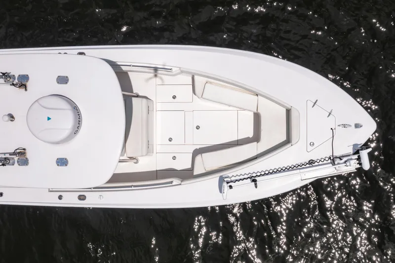 Slide: The Image of Overhead view of a 2014 Contender 30st boat on water, showcasing deck layout. - 14