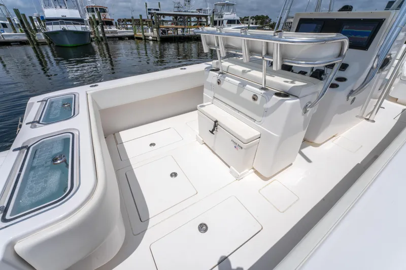 Slide: The Image of 2014 Contender 30st boat interior with seating and storage, docked at marina. - 17