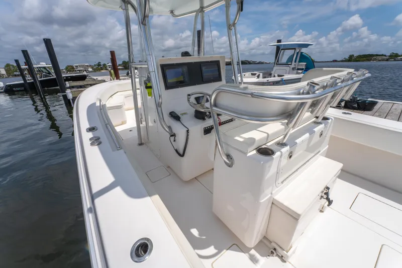 Slide: The Image of 2014 Contender 30st boat with dual consoles docked at marina under clear skies. - 18