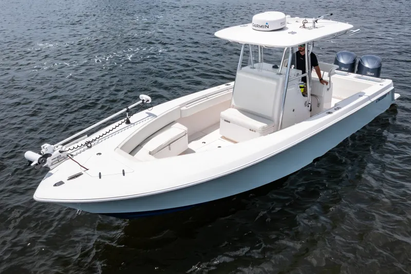 Slide: The Image of 2014 Contender 30st boat on water, featuring dual engines and a sleek design. - 2