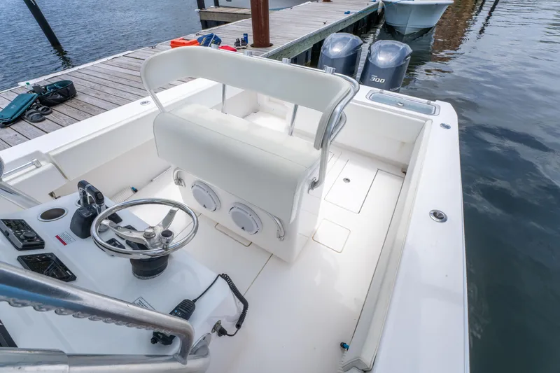 Slide: The Image of 2014 Contender 30st boat interior with steering wheel and seating, docked by the water. - 24