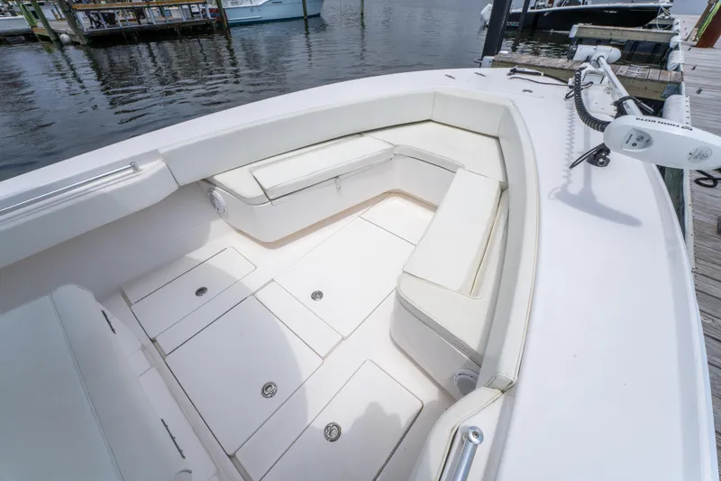 Slide: The Image of 2014 Contender 30st boat with spacious seating and storage, docked by the water. - 27