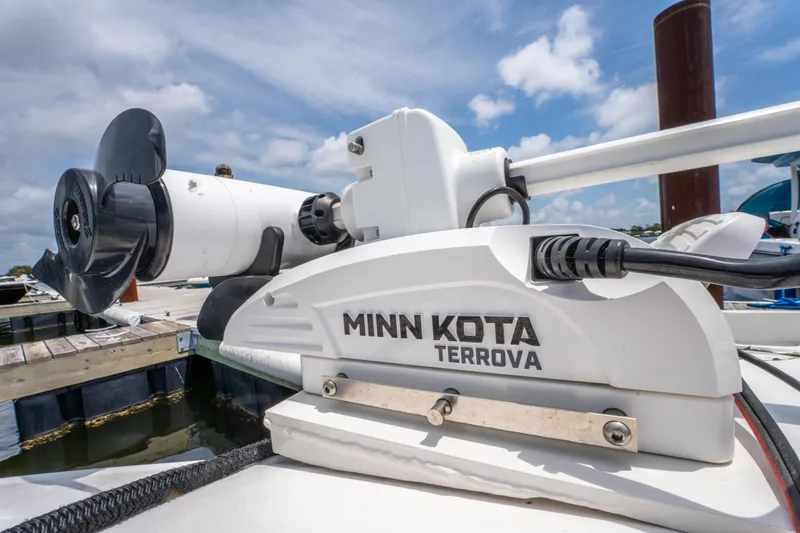Slide: The Image of Minn Kota Terrova motor on 2014 Contender 30st boat at dock, under blue sky. - 28