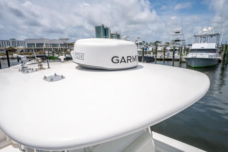 Slide: The Image of 2014 Contender 30st boat with Garmin radar at marina, under cloudy sky. - 29