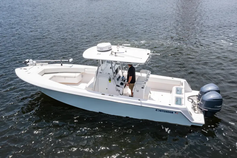 Slide: The Image of 2014 Contender 30st boat on water, featuring dual outboard engines and center console. - 3