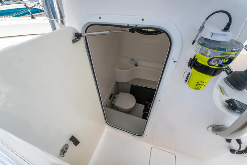 Slide: The Image of 2014 Contender 30st boat interior with compact marine toilet and storage. - 30