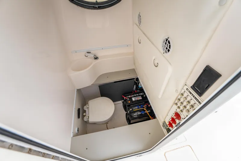 Slide: The Image of 2014 Contender 30st boat interior with toilet and battery compartment. - 31
