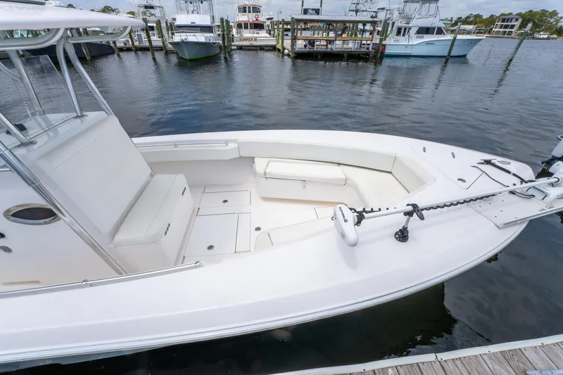 Slide: The Image of 2014 Contender 30st boat docked at marina, featuring spacious seating and sleek design. - 32