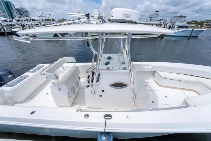 Slide: The Image of 2014 Contender 30st boat docked, featuring spacious deck and modern design. - 33