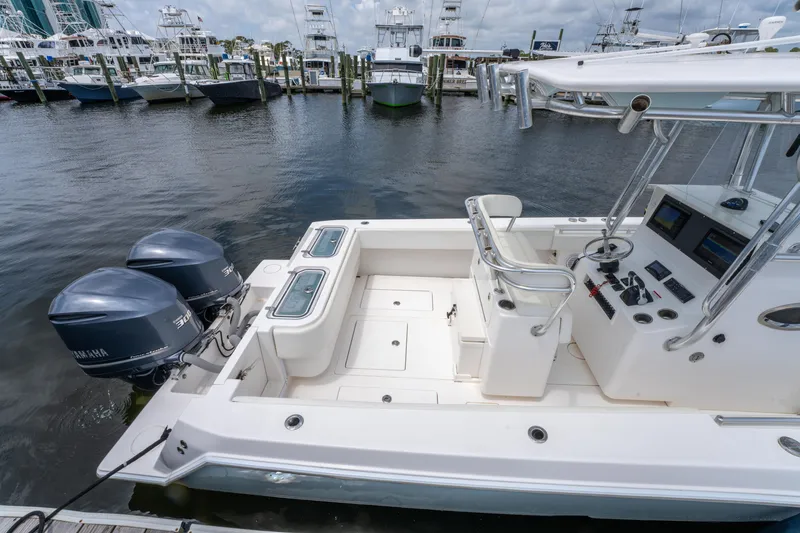 Slide: The Image of 2014 Contender 30st boat with dual engines docked at a marina. - 34