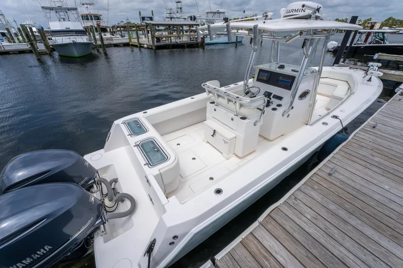 Slide: The Image of 2014 Contender 30st boat docked, featuring dual engines and spacious deck layout. - 35