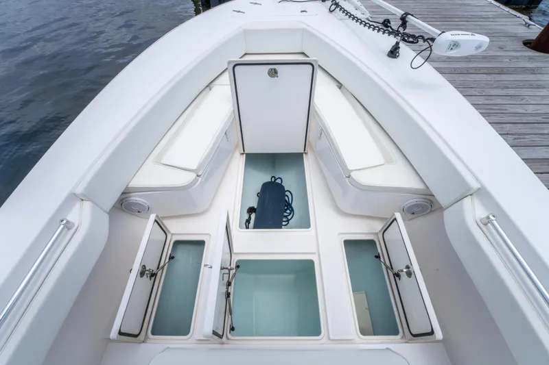 Slide: The Image of 2014 Contender 30st boat interior with open storage compartments and seating. - 36