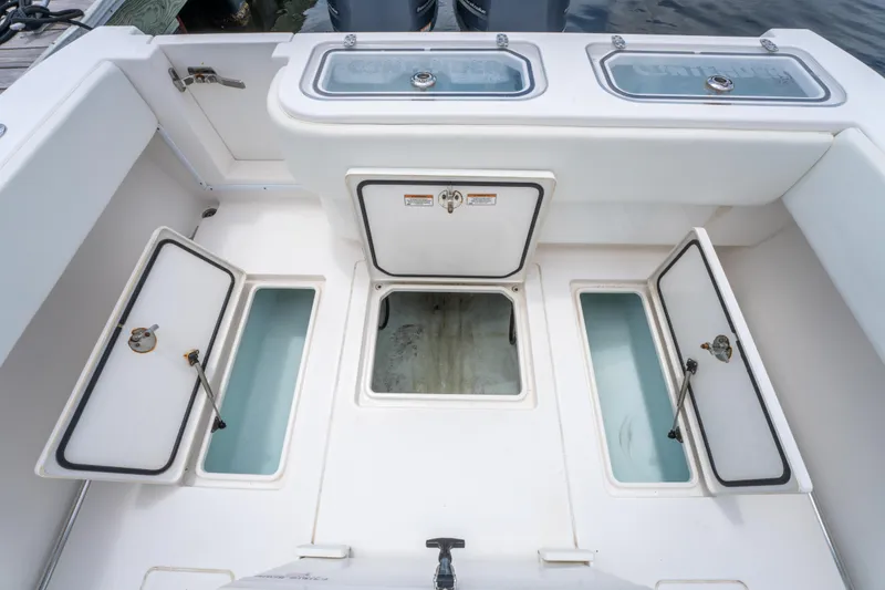 Slide: The Image of 2014 Contender 30st boat deck with open storage compartments and livewells. - 37