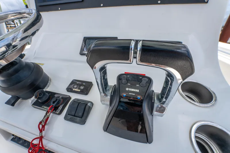Slide: The Image of Control panel of a 2014 Contender 30st boat featuring Yamaha throttle and steering wheel. - 38