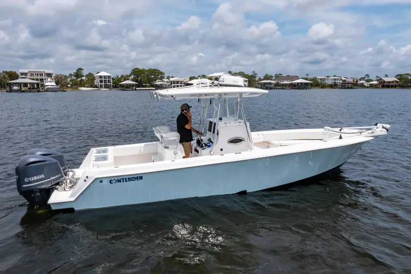 Slide: The Image of 2014 Contender 30st boat on water, featuring Yamaha engines and center console. - 4