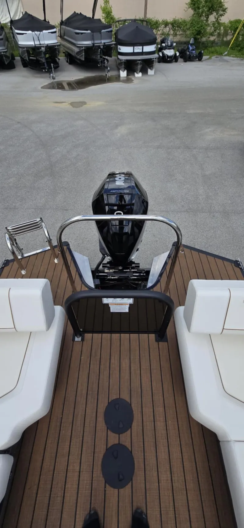 Slide: The Image of 2025 Manitou Explore boat with sleek deck and powerful outboard motor. - 19