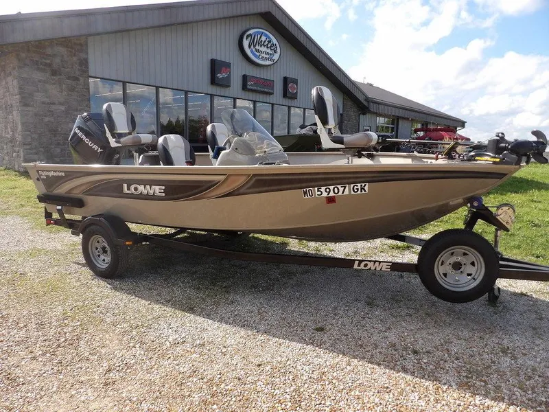 Slide: The Image of 2006 Lowe FM165SC fishing boat on trailer, parked outside dealership. - 0