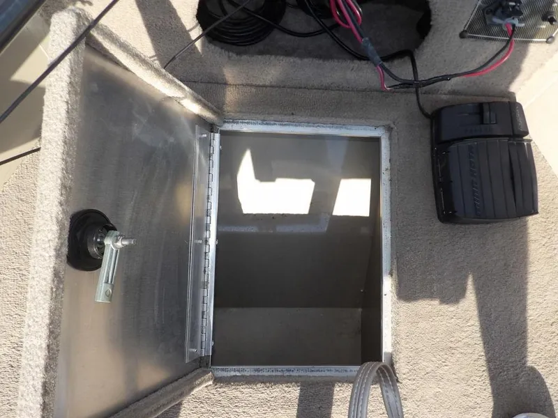 Slide: The Image of Open storage compartment on a 2006 Lowe FM165SC boat, showing interior and wiring. - 14