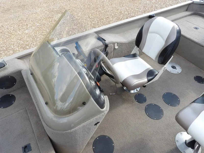 Slide: The Image of 2006 Lowe FM165SC boat interior with steering console and cushioned seat. - 17