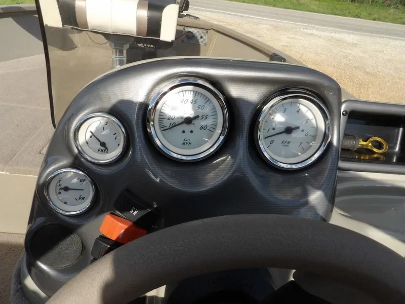 Slide: The Image of 2006 Lowe FM165SC boat dashboard with speedometer, fuel, and RPM gauges. - 20