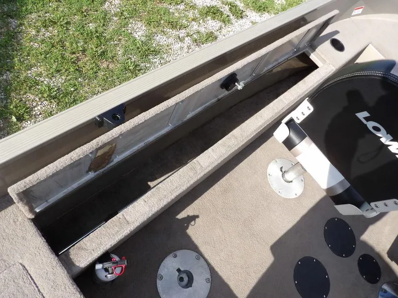 Slide: The Image of 2006 Lowe FM165SC boat interior with storage compartment and seating. - 24